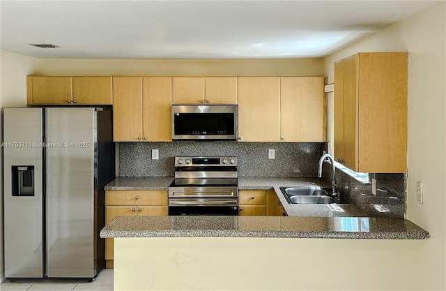 14116 SW 260th St Unit 105, Homestead, FL 33032 - kitchen featuring decorative backsplash, a peninsula, light brown cabinetry, a sink, and stainless steel appliances