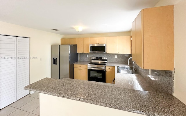 14116 SW 260th St Unit 105, Homestead, FL 33032 - kitchen featuring a sink, light brown cabinets, stainless steel appliances, a peninsula, and visible vents