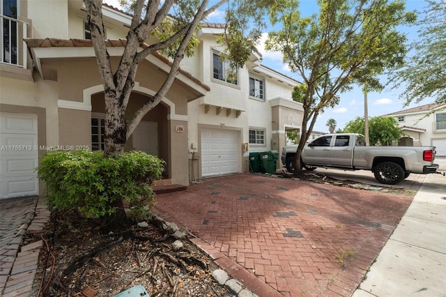 14116 SW 260th St Unit 105, Homestead, FL 33032 - view of front of house featuring a garage, stucco siding, and decorative driveway