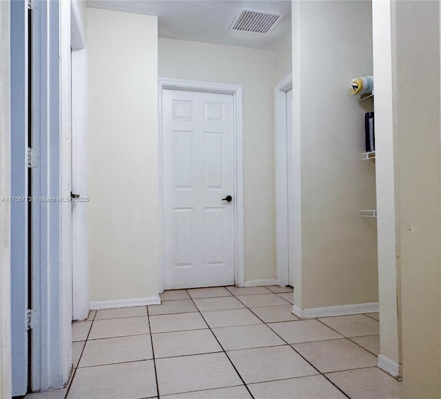 14116 SW 260th St Unit 105, Homestead, FL 33032 - corridor with baseboards, light tile patterned flooring, and visible vents