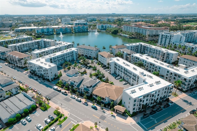 birds eye view of property with a view of city and a water view