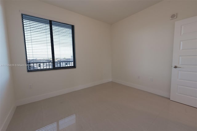 empty room featuring baseboards