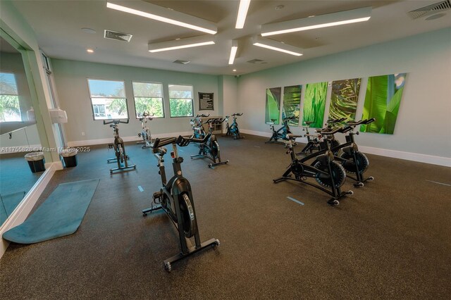 exercise room featuring visible vents and baseboards