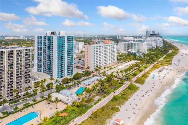 bird's eye view featuring a view of city, a water view, and a beach view