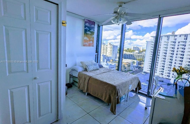 2655 Collins Ave Unit 1505, Miami Beach, FL 33140 - bedroom featuring a city view, multiple windows, light tile patterned flooring, and a wall of windows