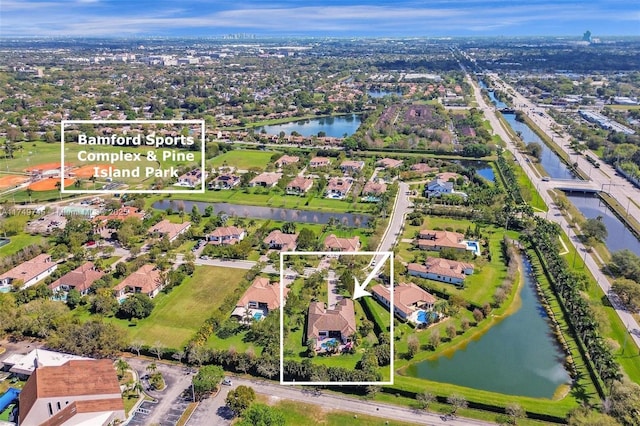 drone / aerial view featuring a water view and a residential view