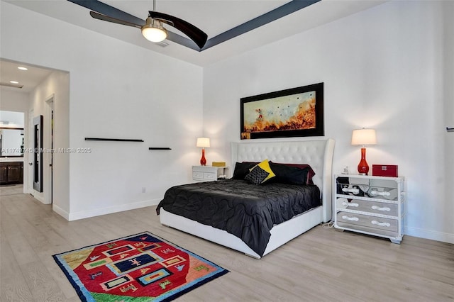 bedroom featuring recessed lighting, a ceiling fan, connected bathroom, light wood-type flooring, and baseboards