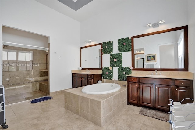 full bath featuring two vanities, a sink, a bath, and a shower stall