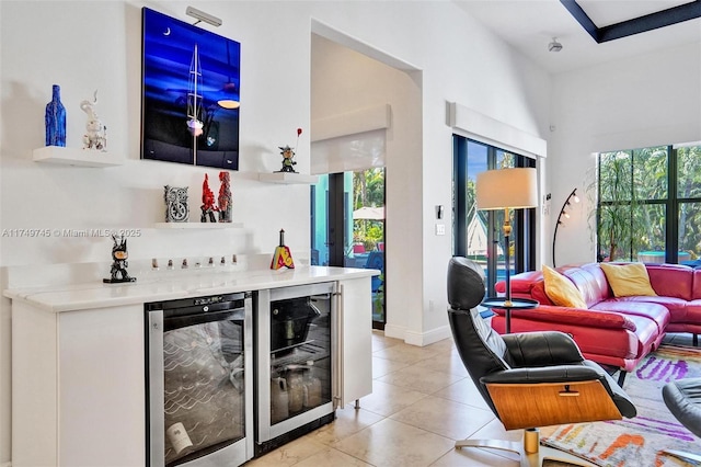 4455 Parkside Rd, Davie, FL 33328 - living room featuring wine cooler, light tile patterned floors, and a bar