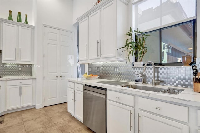 kitchen featuring decorative backsplash, white cabinets, stainless steel dishwasher, and light tile patterned floors