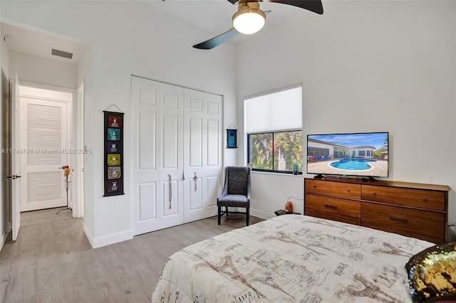 bedroom featuring a closet, wood finished floors, visible vents, and baseboards