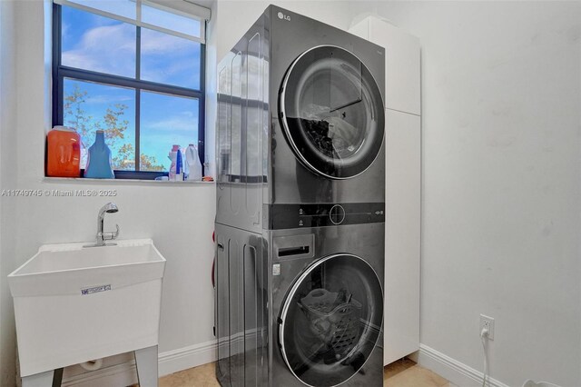 4455 Parkside Rd, Davie, FL 33328 - laundry area with stacked washer / drying machine and light tile patterned floors