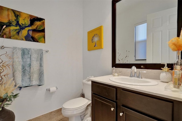 half bathroom with vanity and toilet