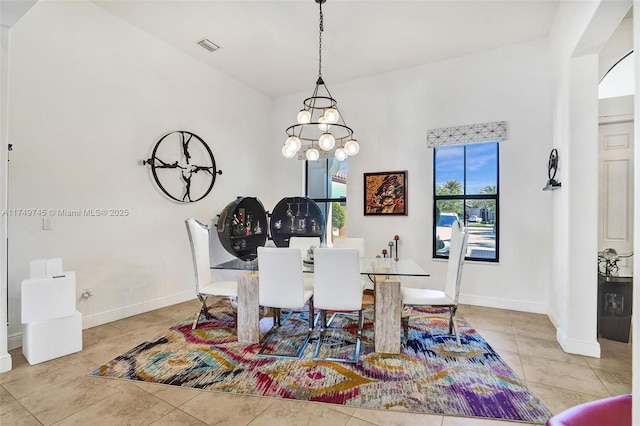 dining space featuring baseboards, a chandelier, visible vents, and tile patterned floors