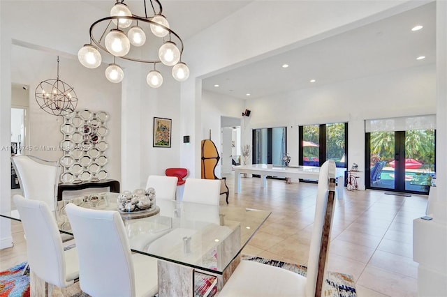 dining space with recessed lighting, french doors, light tile patterned flooring, and a notable chandelier