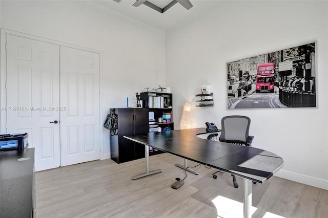 home office featuring wood finished floors and baseboards