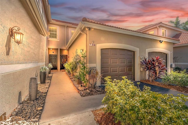 exterior space featuring a garage and stucco siding