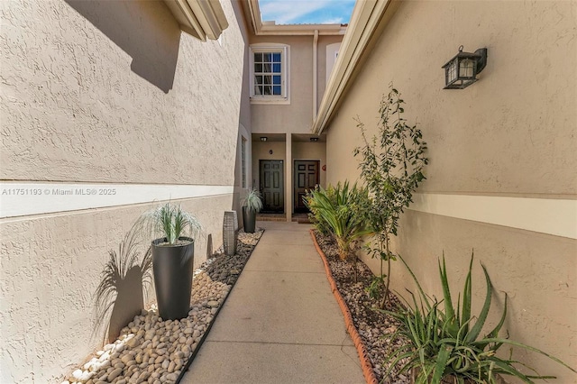 property entrance with stucco siding