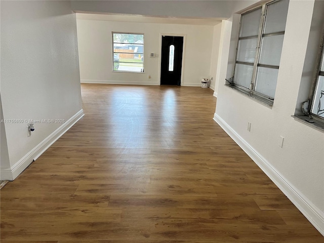 entrance foyer with dark wood-type flooring and baseboards