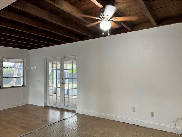 unfurnished room with beam ceiling, a wealth of natural light, and french doors