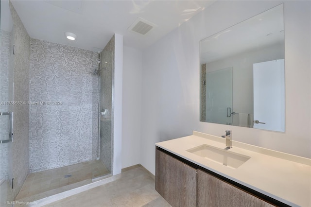 full bathroom with a stall shower, visible vents, and vanity