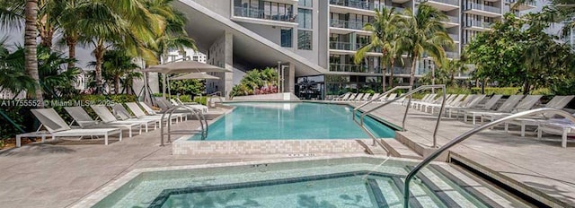 view of pool featuring a patio area and a hot tub