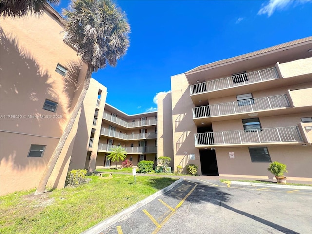 view of property featuring uncovered parking