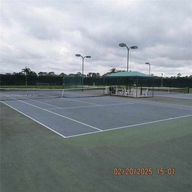 view of sport court with fence