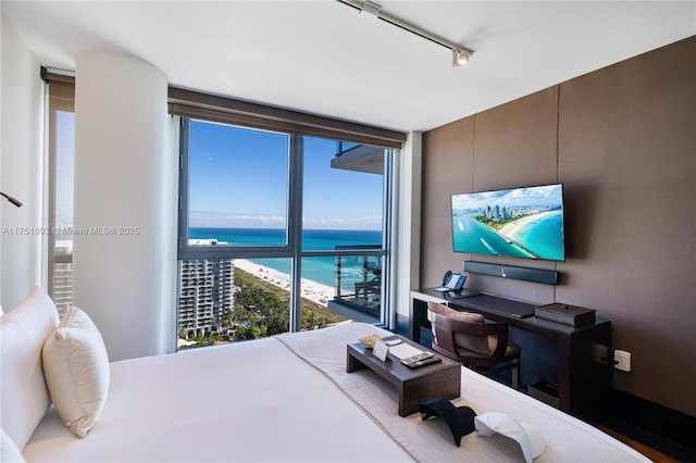 bedroom with expansive windows and track lighting