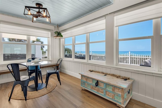 sunroom / solarium with a water view