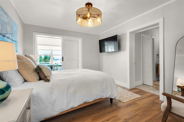 bedroom featuring light wood-type flooring, baseboards, and ornamental molding