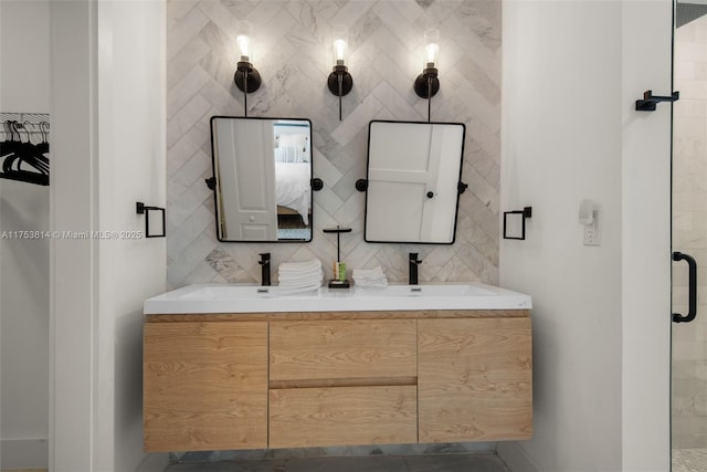 full bath with double vanity, a shower stall, tile walls, and decorative backsplash