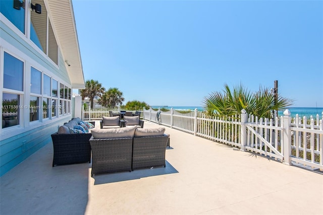 view of patio / terrace with a water view, fence, and an outdoor hangout area