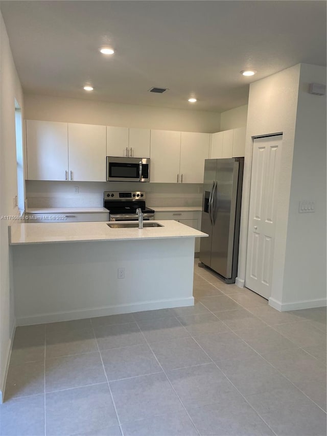 kitchen featuring recessed lighting, light countertops, visible vents, appliances with stainless steel finishes, and a peninsula