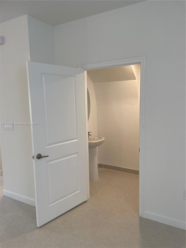 bathroom featuring tile patterned floors and baseboards