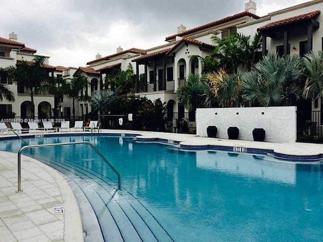 pool featuring a patio area and fence