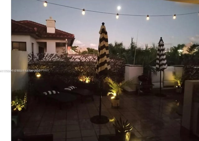 view of patio terrace at dusk