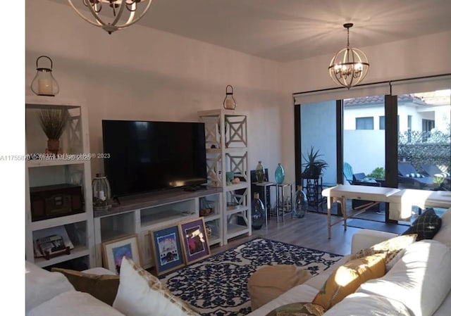 living room featuring a chandelier and wood finished floors