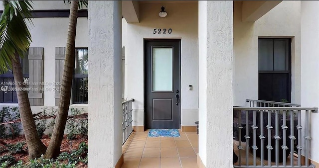 entrance to property featuring stucco siding