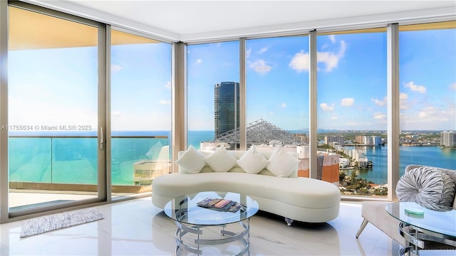 sunroom featuring a water view and a city view