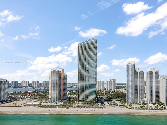 view of city featuring a beach view and a water view