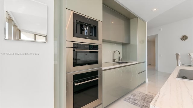 18975 Collins Ave Unit 3504, Sunny Isles Beach, FL 33160 - kitchen featuring modern cabinets, gray cabinets, black electric cooktop, and stainless steel double oven