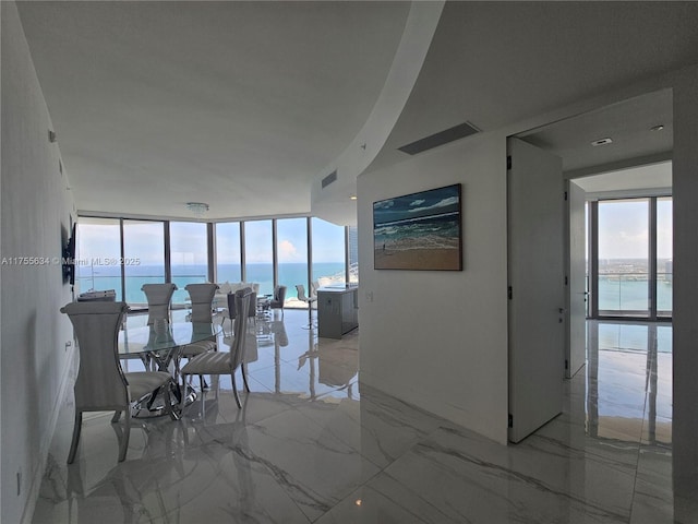18975 Collins Ave Unit 3504, Sunny Isles Beach, FL 33160 - dining space with healthy amount of natural light, a water view, expansive windows, and light marble finish flooring