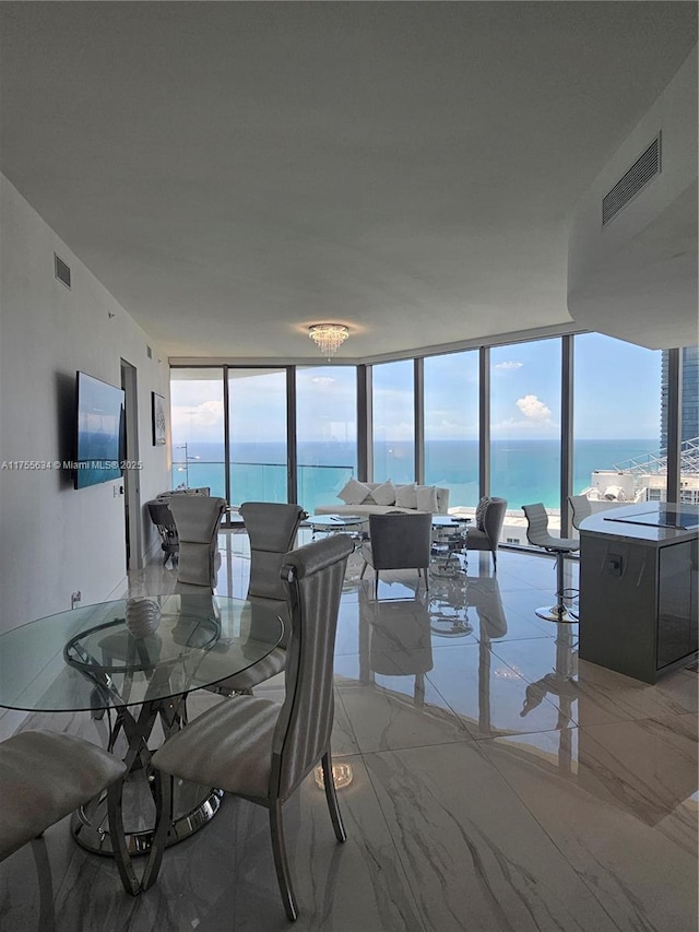 18975 Collins Ave Unit 3504, Sunny Isles Beach, FL 33160 - dining space with floor to ceiling windows, plenty of natural light, light marble finish flooring, and a water view