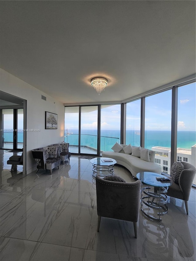 18975 Collins Ave Unit 3504, Sunny Isles Beach, FL 33160 - living room featuring expansive windows, marble tiled flooring, and a water view