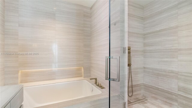 18975 Collins Ave Unit 3504, Sunny Isles Beach, FL 33160 - full bathroom with a bath, a tile shower, and vanity