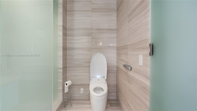 18975 Collins Ave Unit 3504, Sunny Isles Beach, FL 33160 - bathroom featuring toilet and tile walls