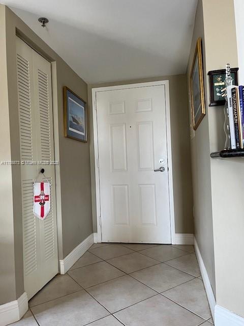 2351 Douglas Rd Unit 1109, Miami, FL 33145 - hall featuring light tile patterned floors and baseboards