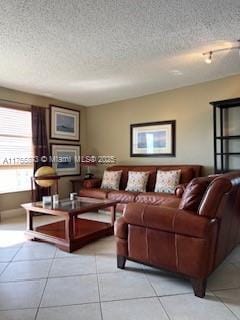 living room featuring light tile patterned floors and a textured ceiling