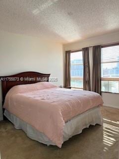 carpeted bedroom featuring a textured ceiling